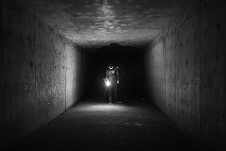 grayscale photo of man holding lamp inside a tunnel, flashlight HD wallpaper
