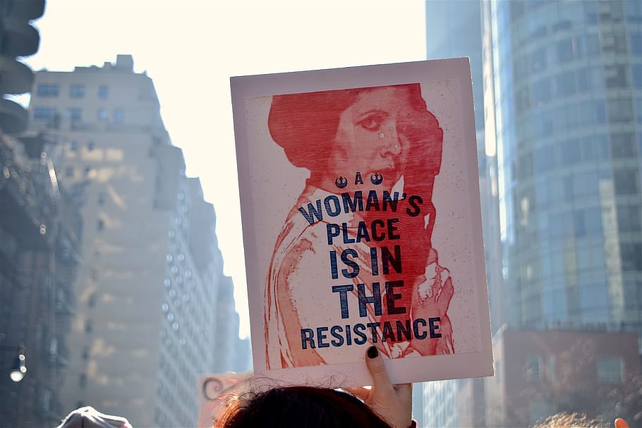 person holding woman's place is in the resistance print, women's march, HD wallpaper