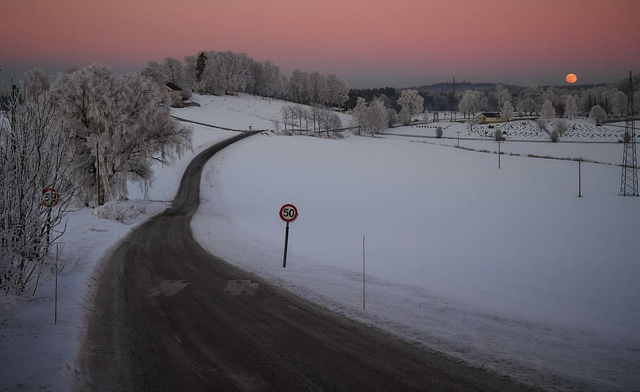 gray asphalt road between white snow field during sunset, photo of road surrounded by sno HD wallpaper