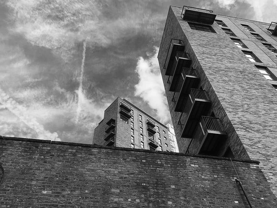 low angle photography of building, grayscale photography of buildings under cloudy sky during daytime HD wallpaper