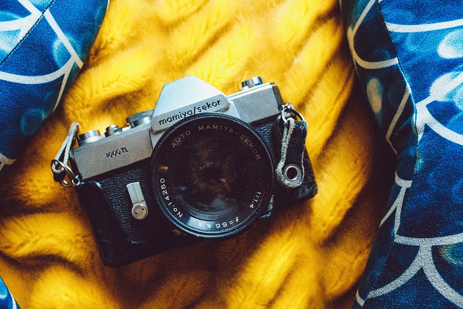 black point-and-shoot camera, black and gray SLR camera on yellow textile HD wallpaper