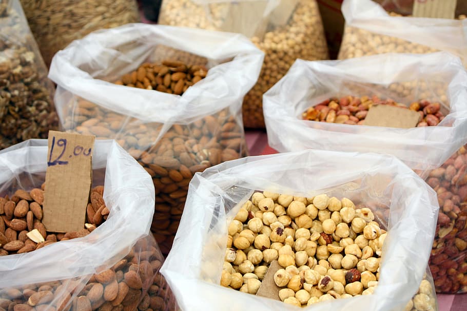 four clear plastic pack filled with nuts, hazelnuts, almonds HD wallpaper