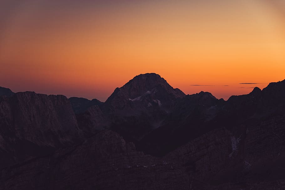 mountains, peaks, cliffs, sunset, dusk, orange, sky, shadows HD wallpaper