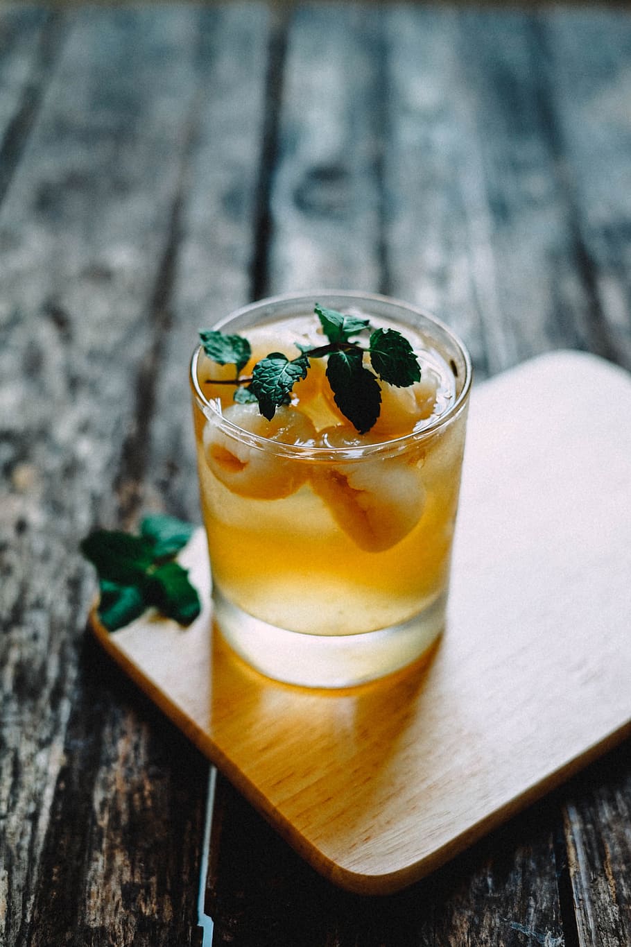 clear drinking glass filled with yellow liquid, wooden, table HD wallpaper