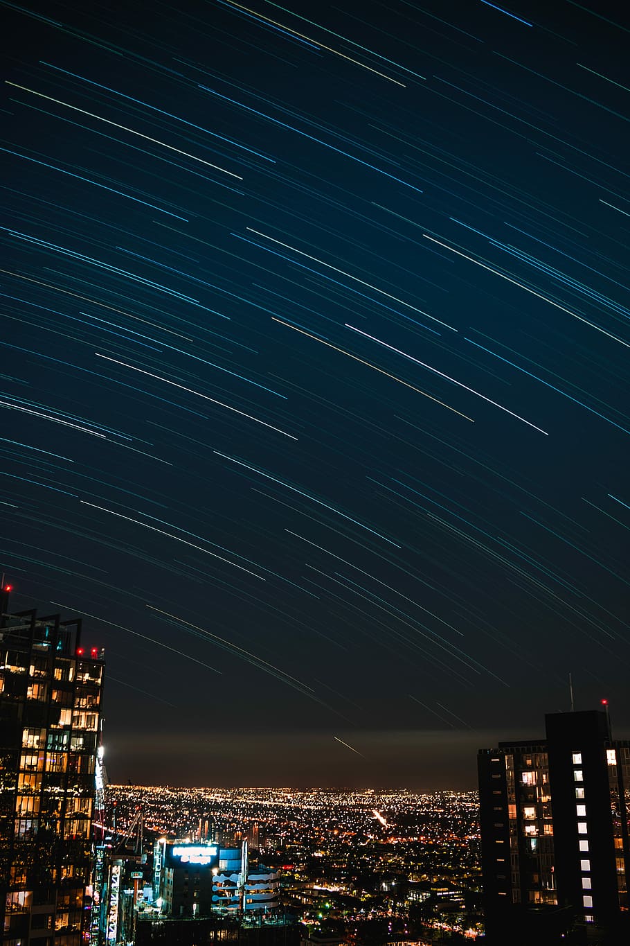 photography of meteor shower, timelapse photograph of city, building