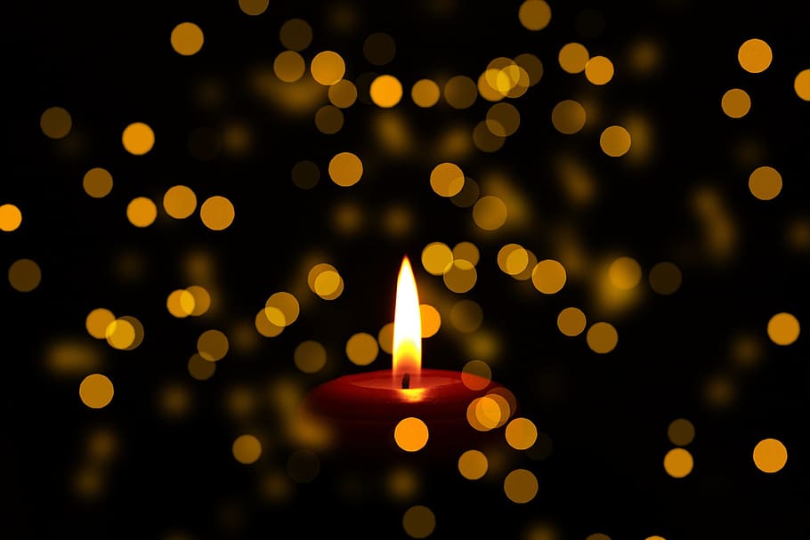 close up photo of lighted red candle bokeh photography, mourning