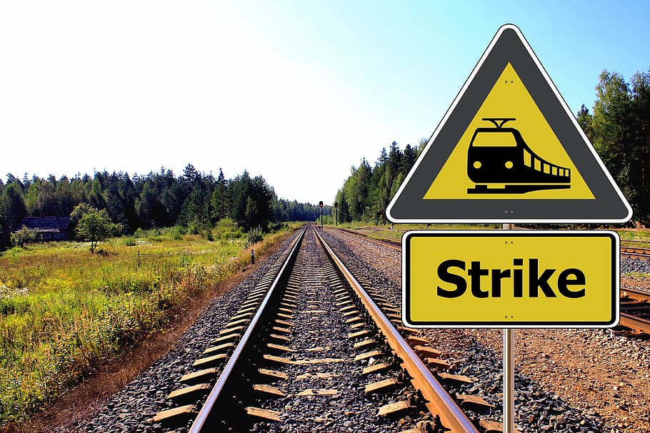 yellow-and-black train strike signage at daytime with no train HD wallpaper
