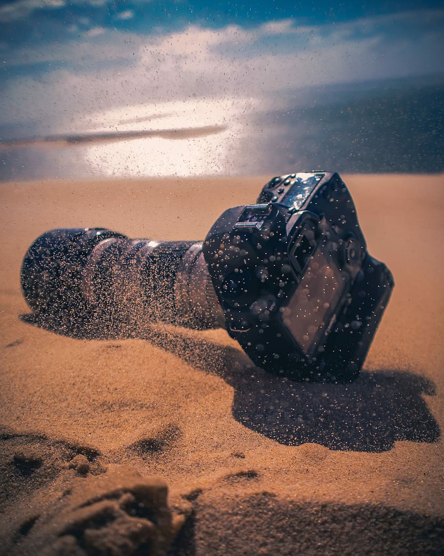 black DSLR camera on sand, black DSLR camera, lens, beach, dust HD wallpaper