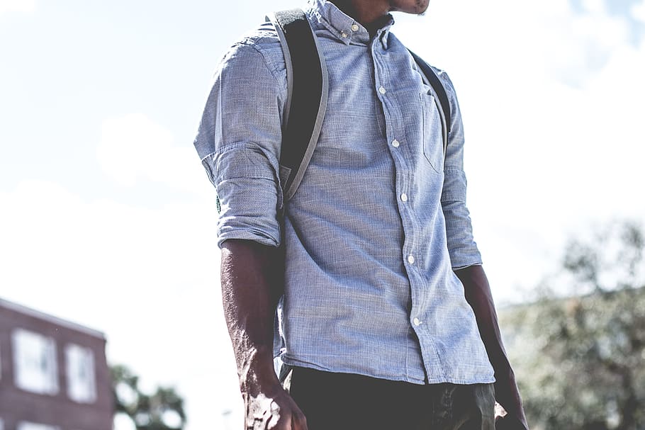 man standing carrying backpack, man wearing gray dress shirt and black backpack outdoors, HD wallpaper