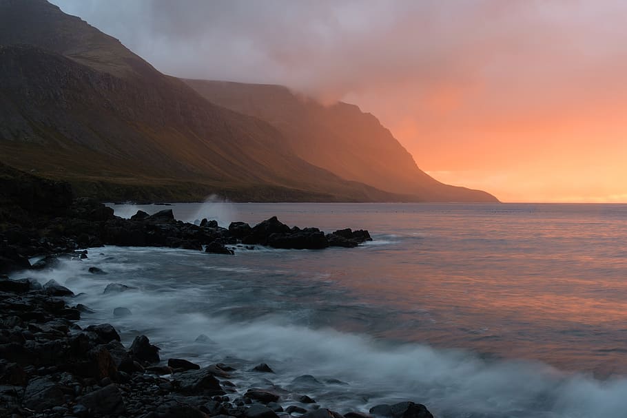 waves, ocean, sea, sunset, clouds, sky, mountain, rocks, water HD wallpaper