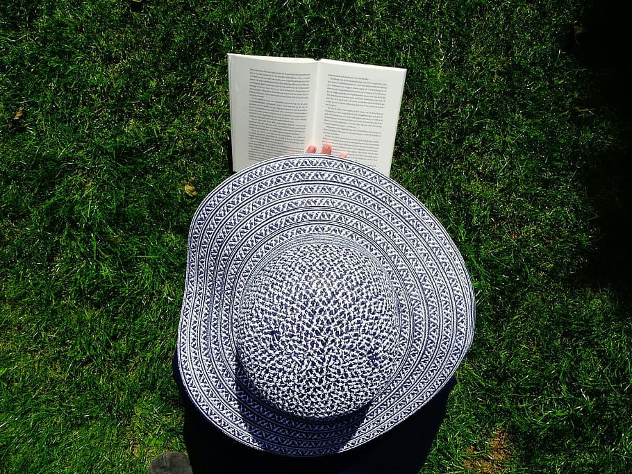 person holding gray sun hat, book, read, relax, grass, books HD wallpaper