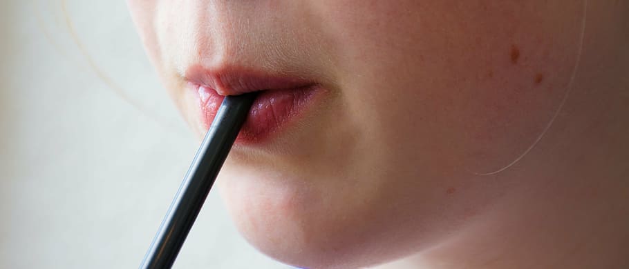 woman zipping from black straw in close-up photography, drinking straw HD wallpaper