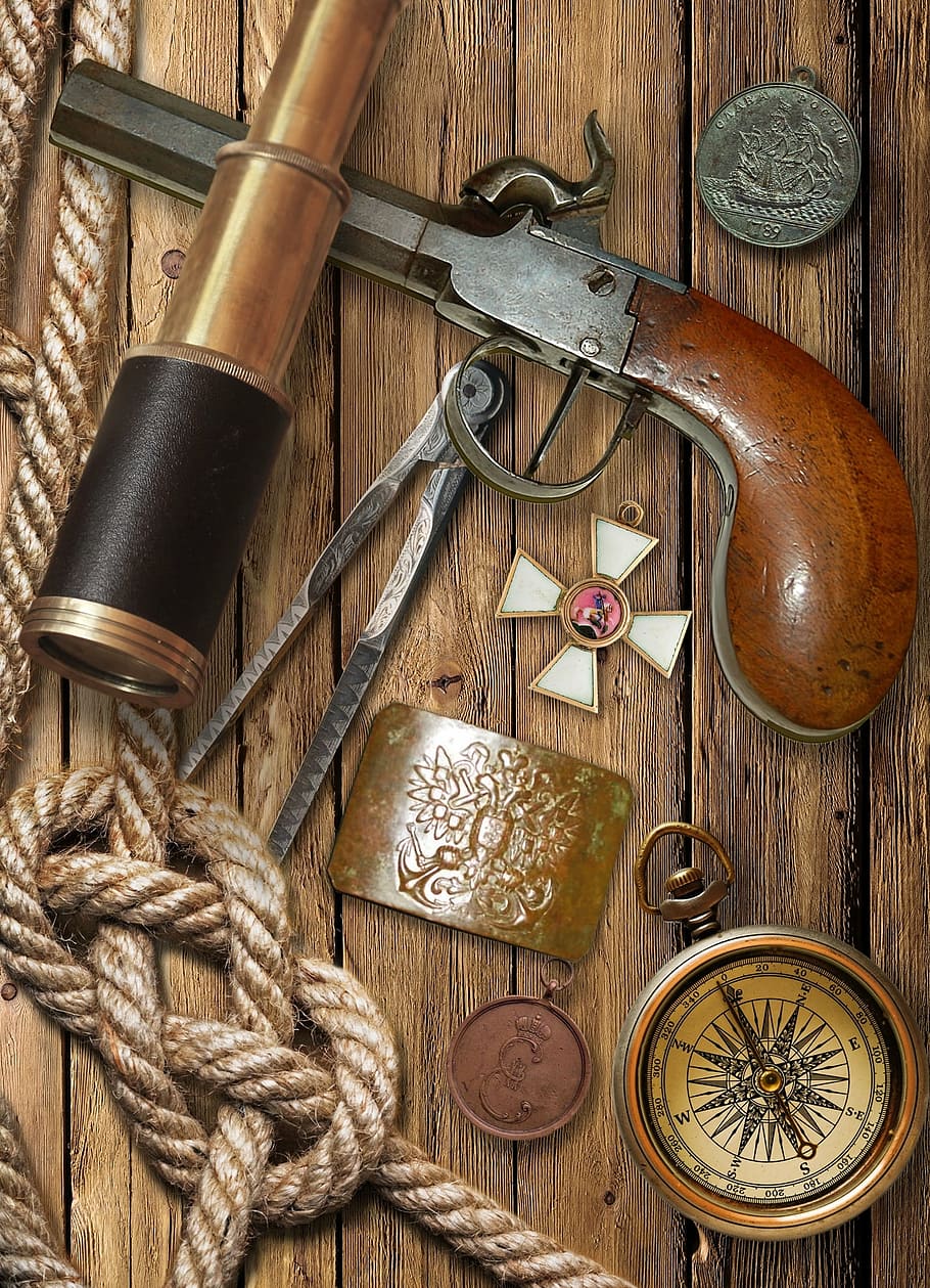 brown flintlock pistol and compass, spyglass, holy order, george