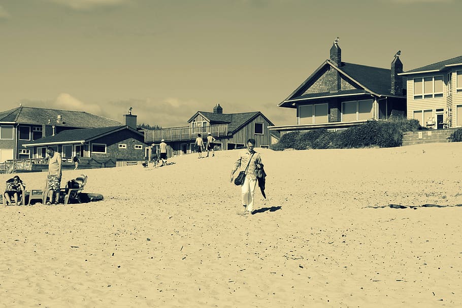 person walking on seashore near houses, gray, scale, photo HD wallpaper