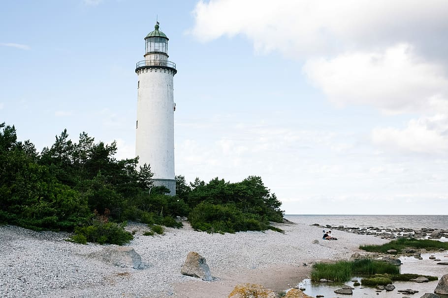 white lighthouse near body of water, lighthouse at the seashore during day HD wallpaper