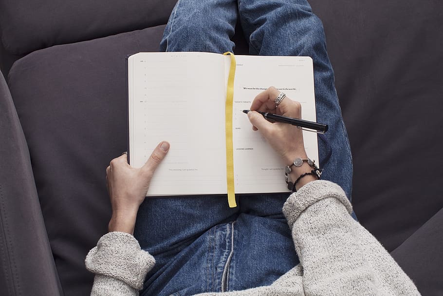 person writing on book, journal, notepad, notebook, pen, pencil HD wallpaper