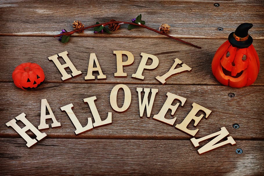 photo of brown Happy Halloween and orange jack-o-lantern decors HD wallpaper