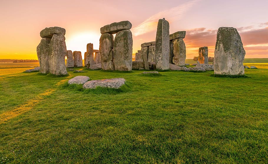 rock formation on green grass lawn, sunrise, stonehenge, ancient