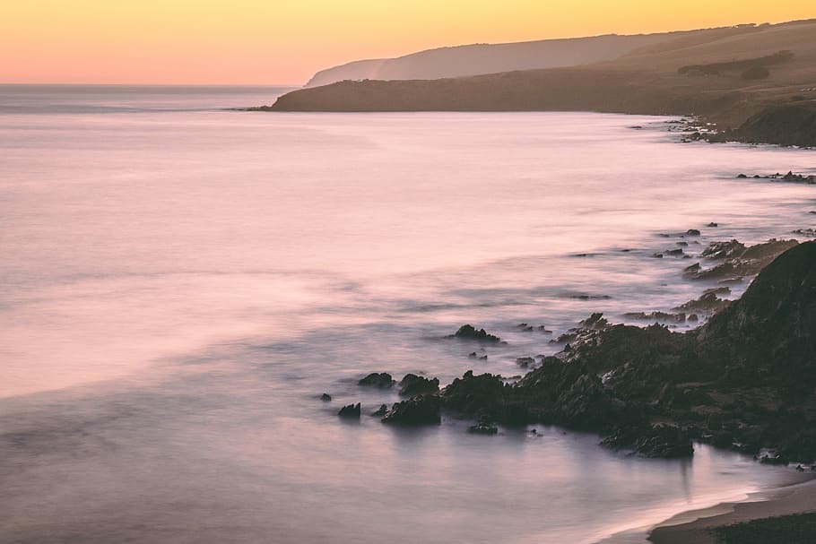 calm ocean waves, rocks besides the seashore, sunset, sunrise HD wallpaper