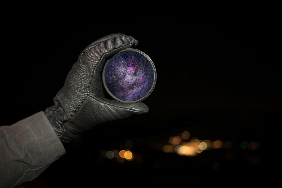 person holding round purple ornament, wearing, gray, glove HD wallpaper