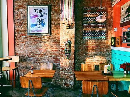 two square brown wooden dining tables near brown brick wall, two brown wooden side tables inside store HD wallpaper