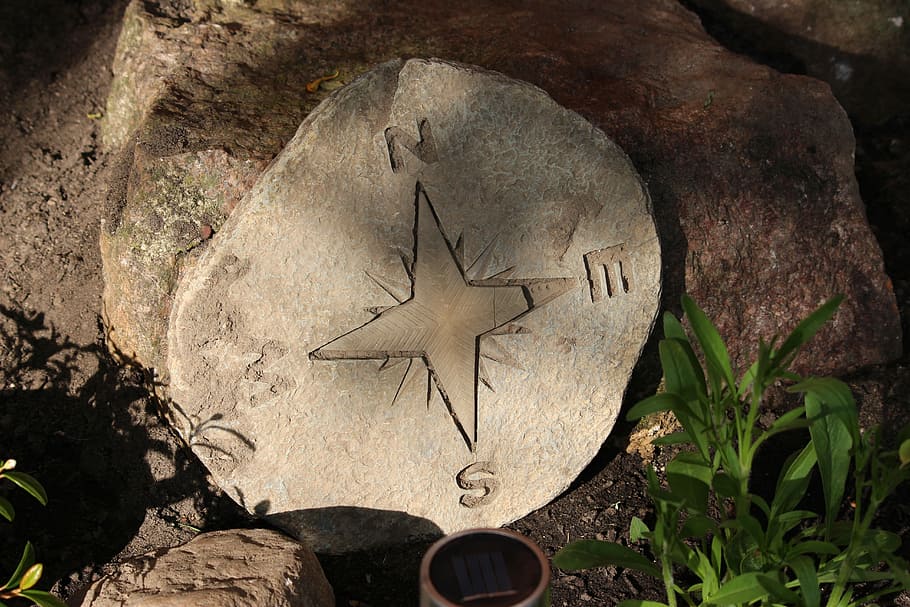 photo of compass drawn in stone, Sextant, Navigation, points of the compass