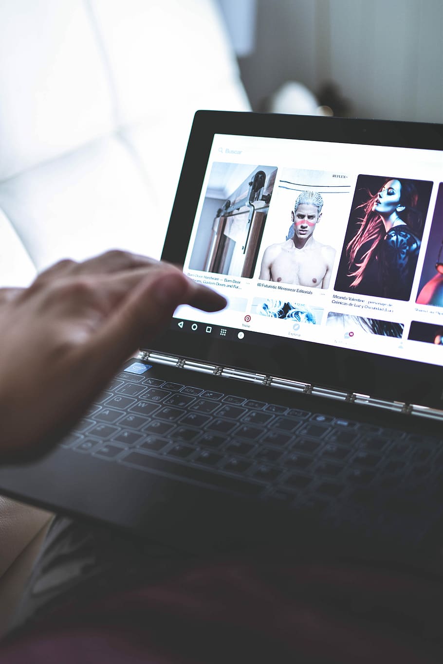 person using laptop watching photos, person using black laptop computer