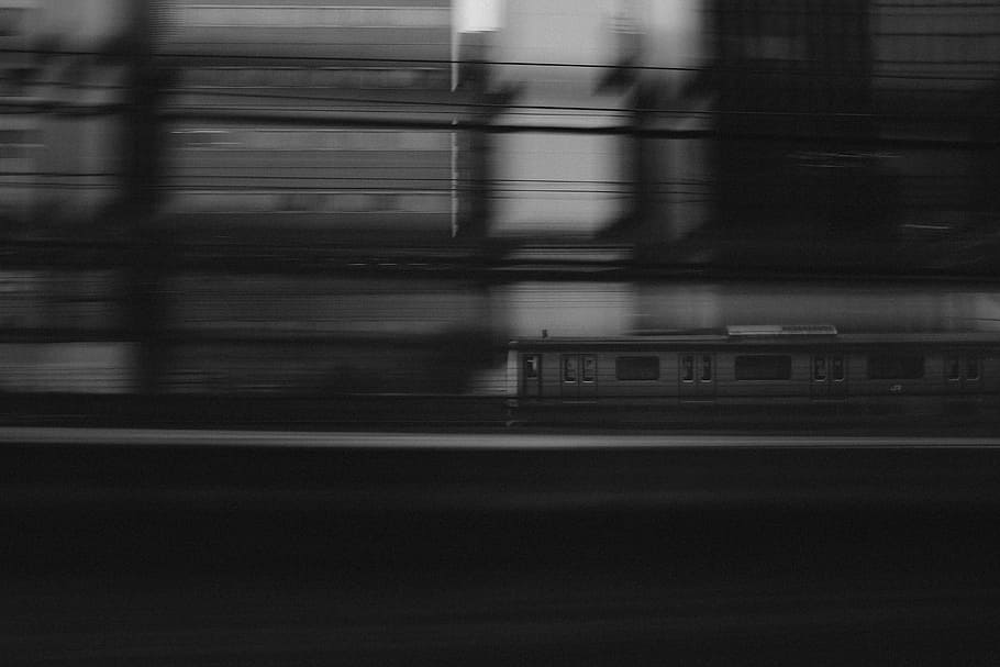 Black and white train moving past in a blur in Tokyo, untitled HD wallpaper