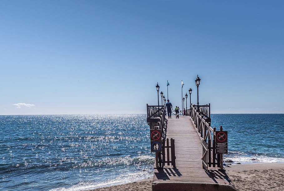 several people walking on wooden dock during daytime, jetty, marbella