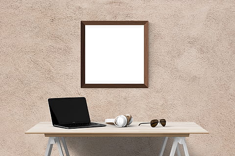 wall mirror over laptop, headphones, and eyeglasses on table HD wallpaper