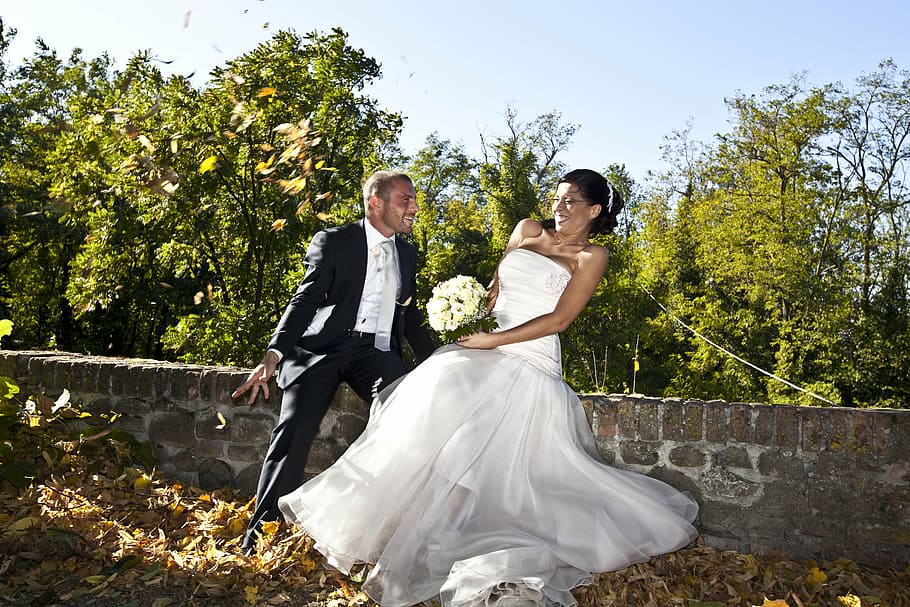 male and female sitting on concrete bench, marriage, formal wear