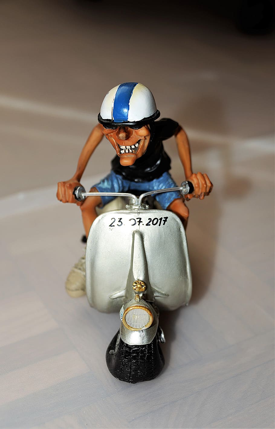 man riding on gray motor scooter miniature on white surface HD wallpaper