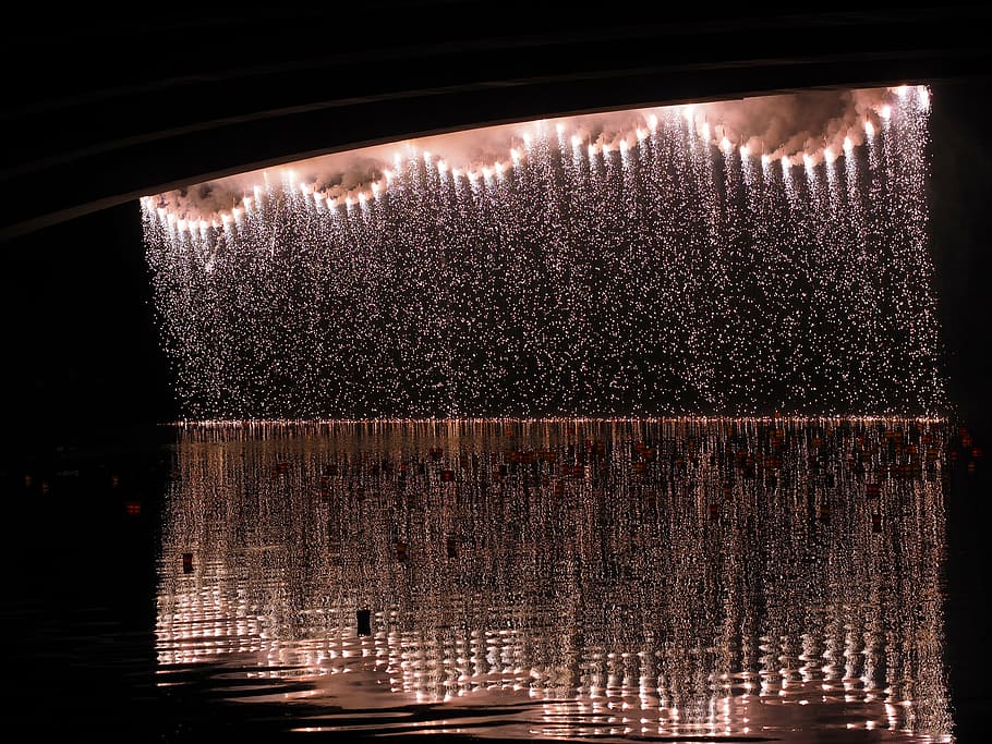 fountain with lights at night, fireworks, silver rain, river HD wallpaper