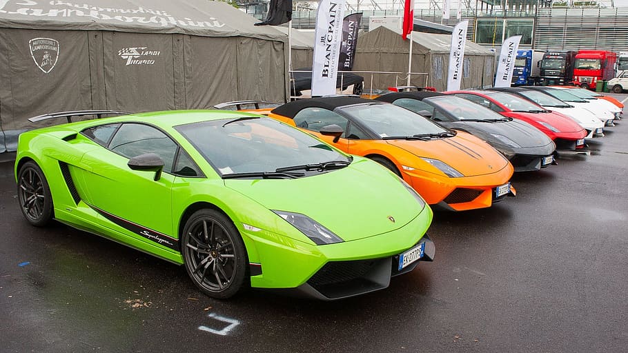 assorted-color Lamborghini Gallardo coupes parked in front of canopies at daytime HD wallpaper