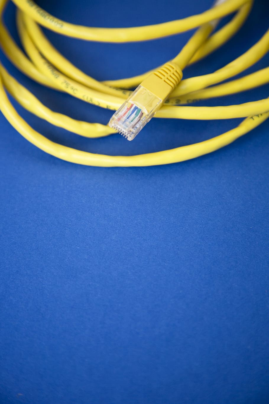 Ethernet cable on blue surface, yellow ethernet cable, tech, wired, HD wallpaper