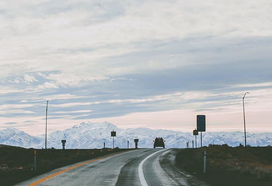 car on almost empty road, gray pave road during daytime, silhouette HD wallpaper