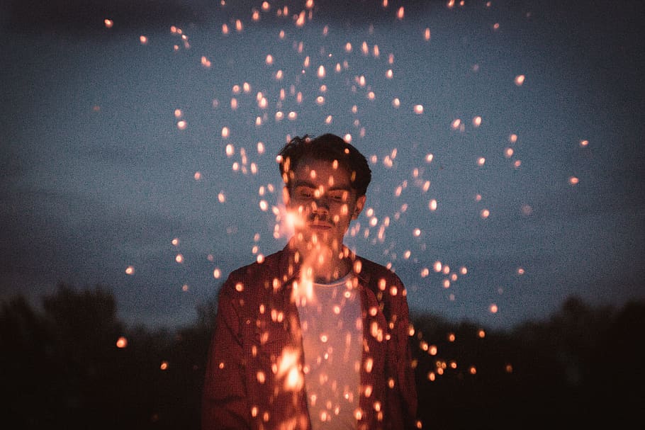 man holding sparkler, photography of man playing fire, bonfire HD wallpaper
