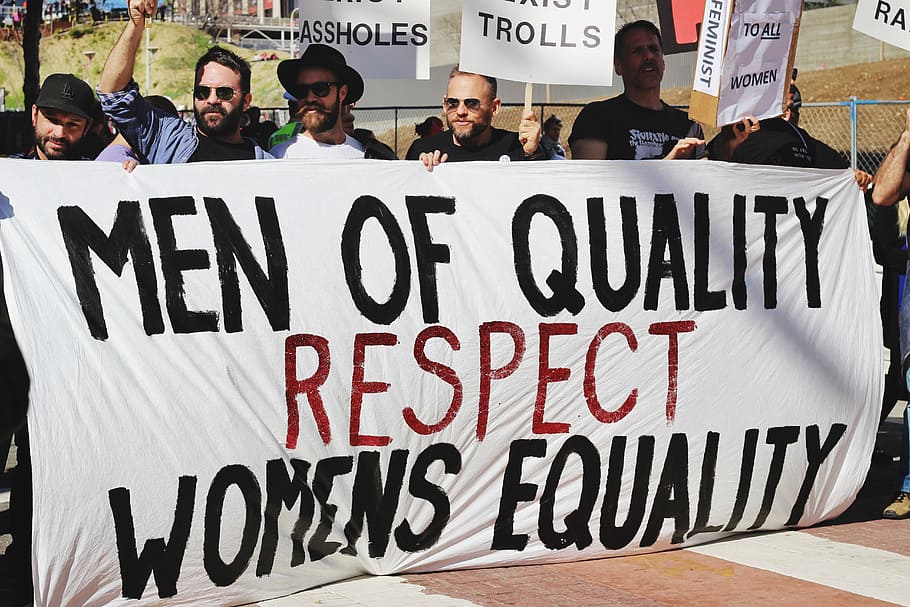 men holding white, black, and red Men of quality respect womens equality banner on road, group of men holding signage of men of quality respect womens equality HD wallpaper