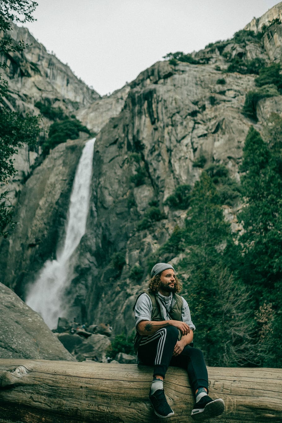 Let’s relax, man sitting on tree log, waterfall, hiking, green HD wallpaper