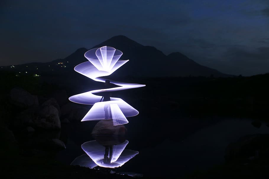 purple outdoor light turned on, time lapse photography of spiral blue light at nighttime HD wallpaper