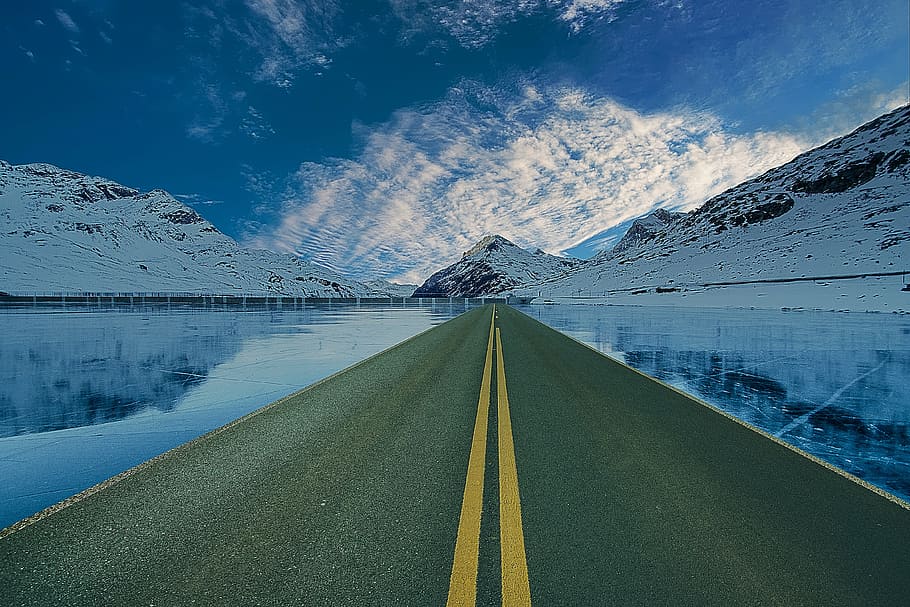 landscape photography of pavement road near body of water and snow covered mountain HD wallpaper