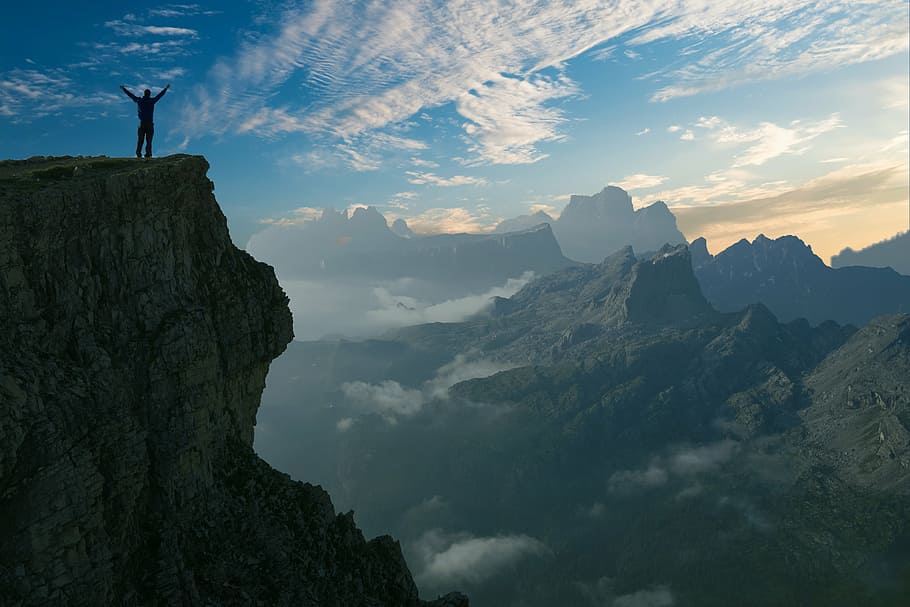 silhouette photo of person on cliff during daytime, mountain HD wallpaper