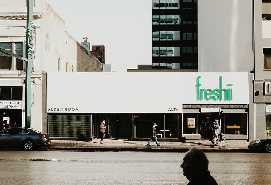 Freshii store facade, gray sedan park beside Freshii building during daytime HD wallpaper