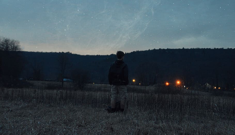 grass, lights, man, mountain, person, sky, stars, trees, night HD wallpaper