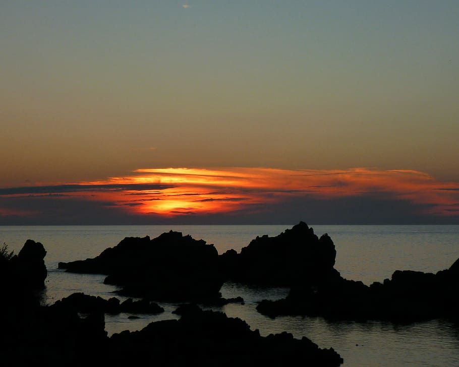 stock rock in body of water, landscape photography of seashore and rock formations at sunset HD wallpaper