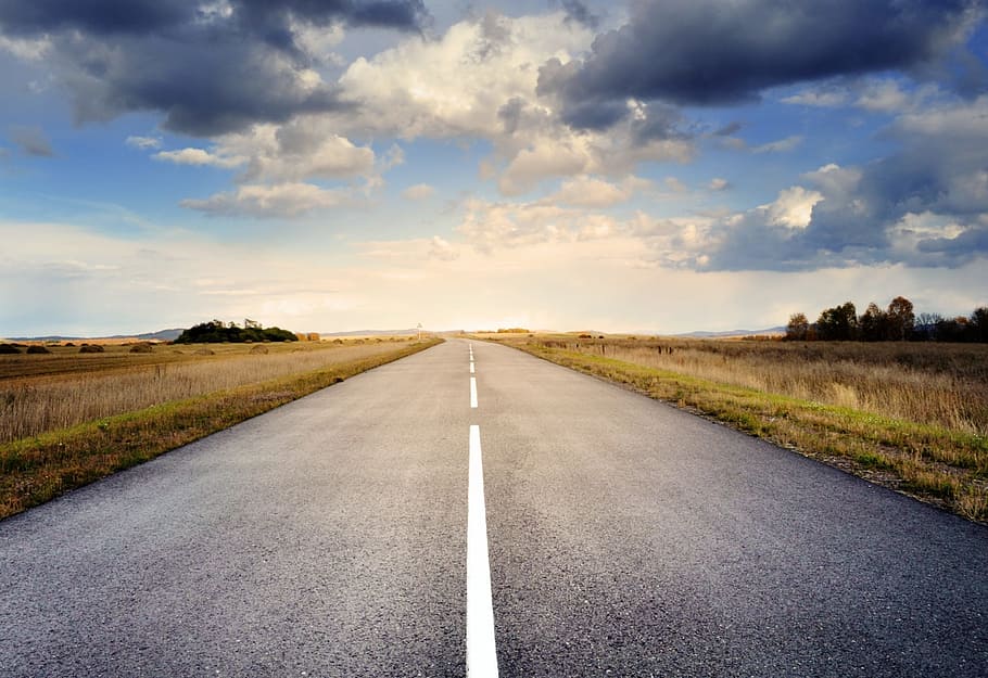 landscape photo of gray concrete road between grass, asphalt HD wallpaper