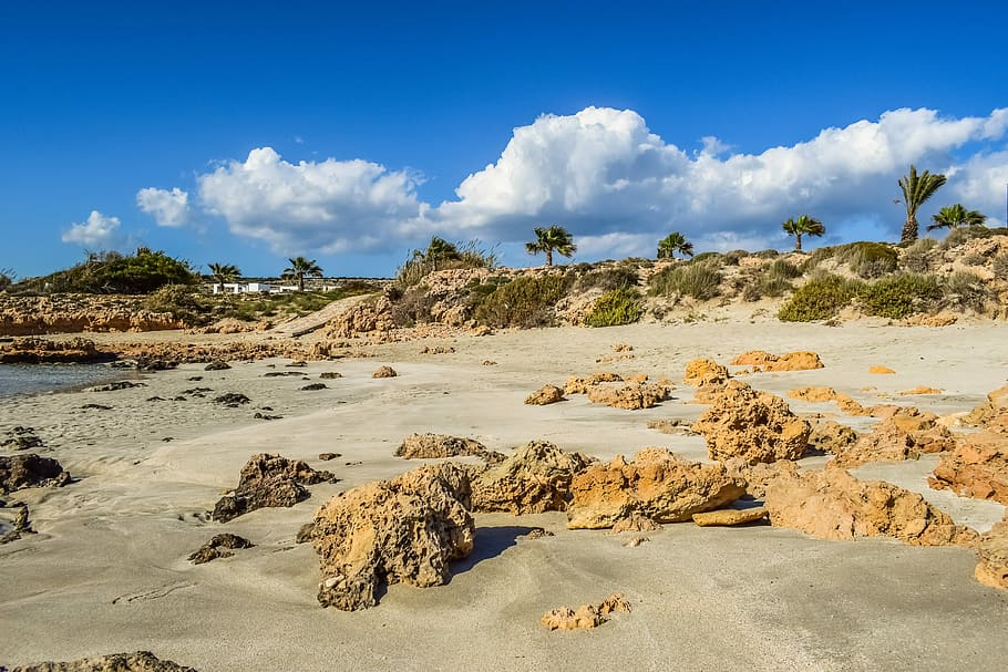 brown rock formations, beach, sand, nature, sky, clouds, scenery HD wallpaper