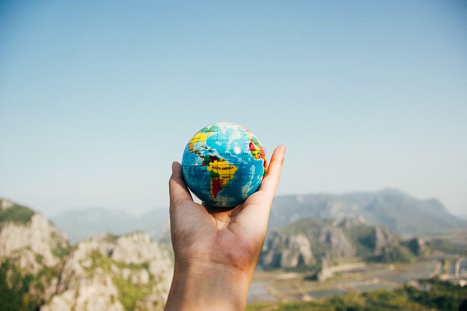 person holding globe, global, map, round, colorful, outdoor HD wallpaper