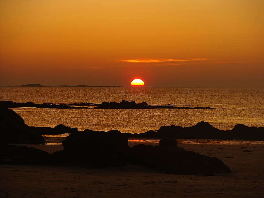 sun dipping, sea, rocks, sunset, beach, nature, dusk, coastline HD wallpaper