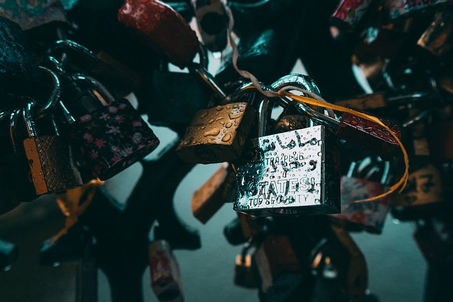 closeup photo of padlocks on metal grill, selective focus photograph of silver padlock HD wallpaper